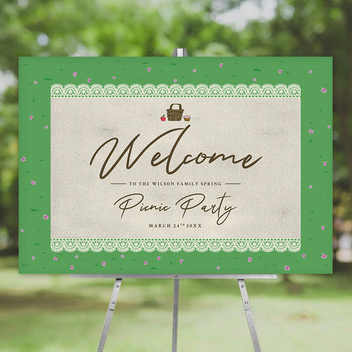 spring picnic party welcome sign with picnic basket illustration, lace border, green grass pattern, tiny pink flowers, and elegant script lettering