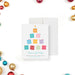 holiday greeting card with a colorful sticky note Christmas tree with festive seasonal words and modern office-inspired design-front