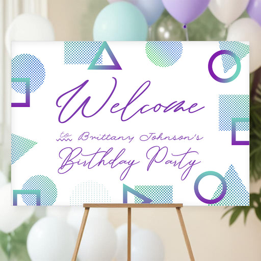Birthday welcome sign with purple and teal geometric shapes and modern script text for a stylish party entrance
