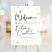 surprise birthday party welcome sign with gold confetti, modern script lettering, and personalized milestone birthday details displayed on an easel