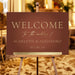 terracotta wedding welcome sign with elegant lettering, custom couple names, warm accent details, and formal reception display on an easel