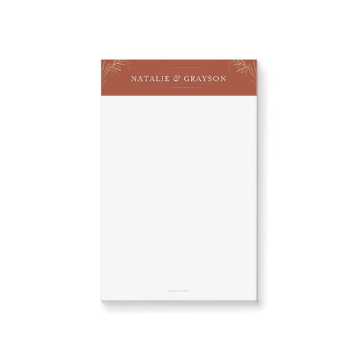 Personalized terracotta wedding notepad with gold foliage header and custom couple names