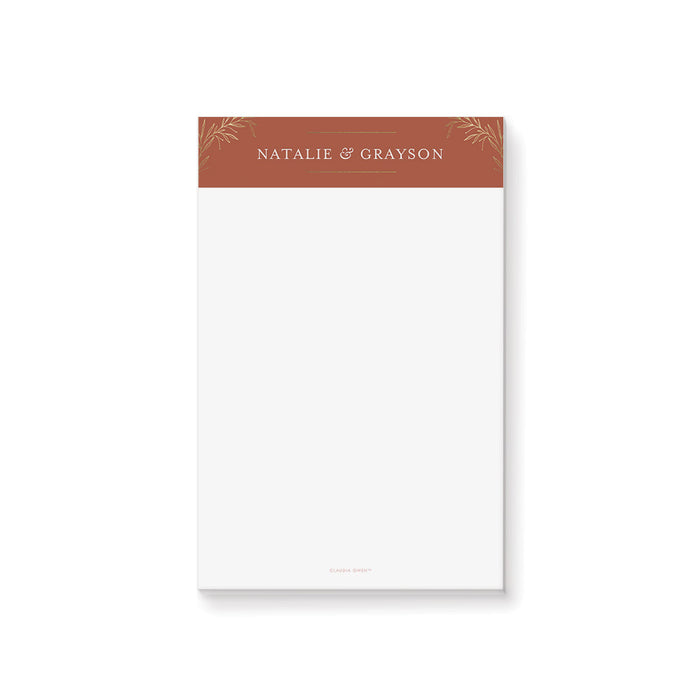 Personalized terracotta wedding notepad with gold foliage header and custom couple names