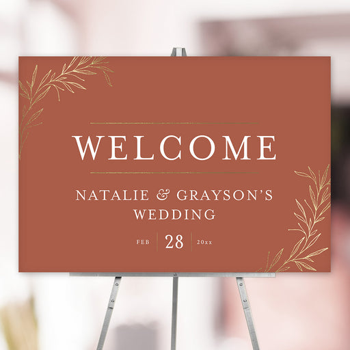 Terracotta wedding welcome sign with gold botanical leaves personalized with couple names