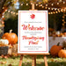 thanksgiving welcome sign with watercolor autumn leaves displayed on an easel for a fall celebration