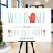 Holiday party welcome sign with mitten and martini glass illustrations displayed on an easel for a festive year end celebration.