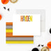 Personalized Halloween note card featuring colorful orange, yellow, and gray lettering on modern stationery.-front-back