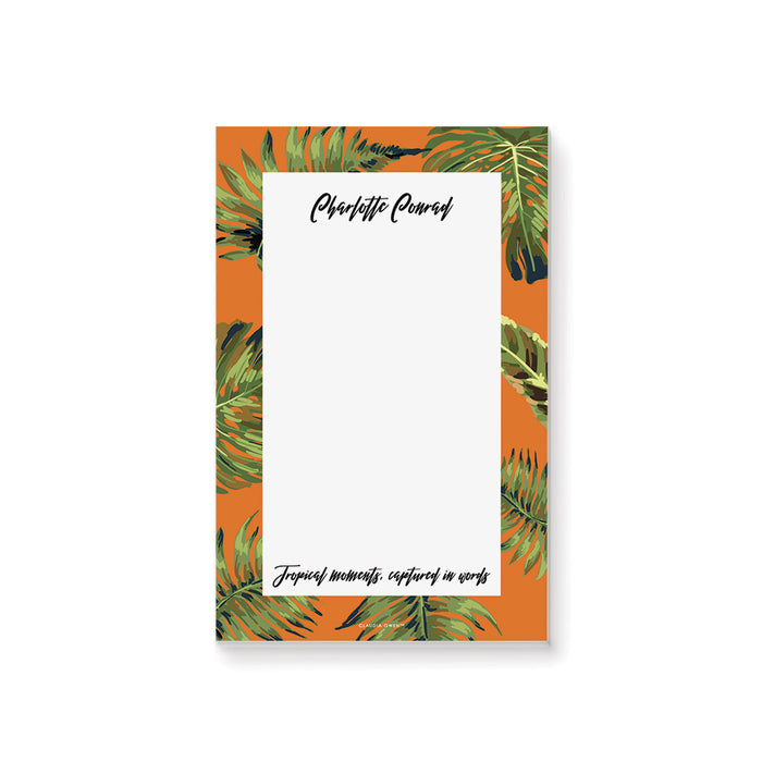 Personalized notepad with an orange background and green leaves, perfect as custom bachelorette party favors or tropical-themed gifts.