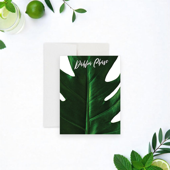 personalized tropical note card featuring a large green monstera leaf design and a custom name in script lettering.-front