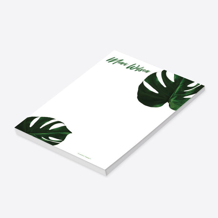 personalized monstera leaf notepad with custom name, bold green tropical leaves, and clean white writing space-side