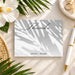 tropical wedding thank you card with soft palm shadow design and elegant script lettering for a beach or garden wedding-front