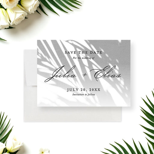 tropical wedding save the date card with soft palm shadow design and elegant script lettering for a beach or garden wedding-front