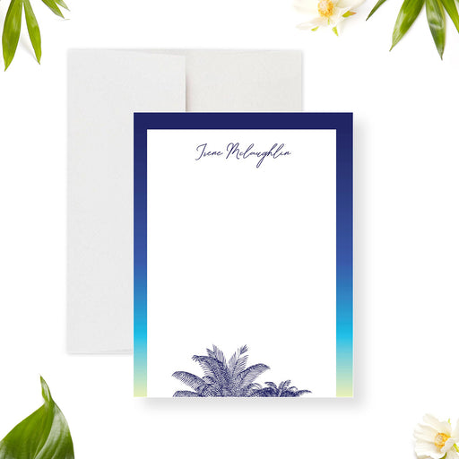 Personalized note card with a white front with a blue and green border, palm tree illustrations, and a name in script. Shown with a white envelope.