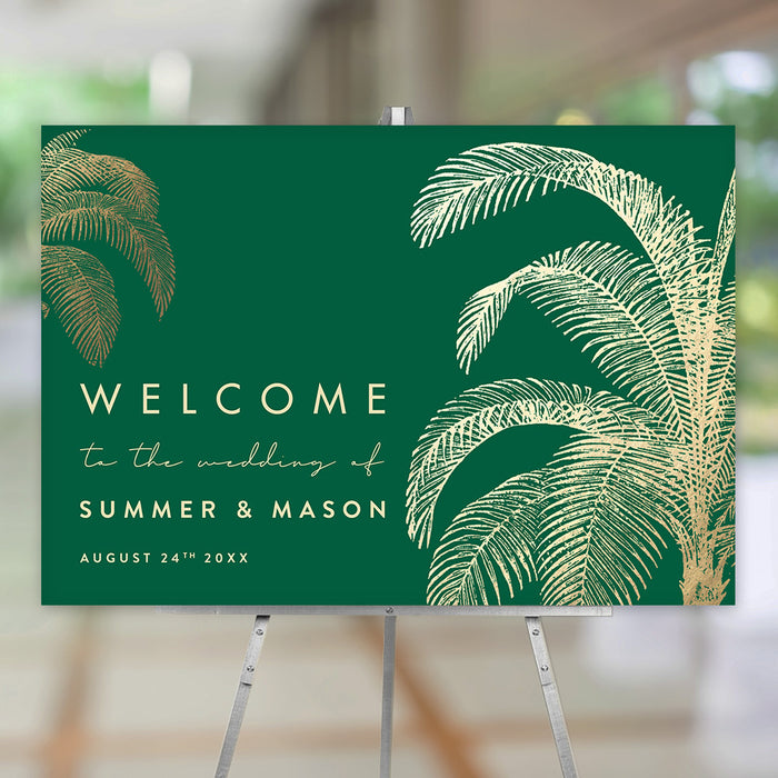 tropical wedding welcome sign with gold palm tree illustrations on an emerald green background for destination weddings and beach ceremonies