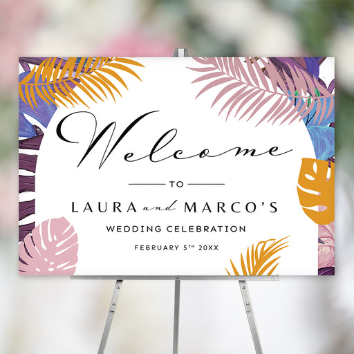Botanical wedding welcome sign featuring colorful tropical palm and monstera leaves