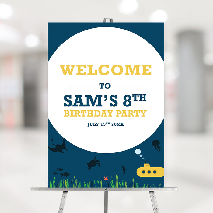 Underwater-themed birthday welcome sign featuring a yellow submarine, sea creatures, and ocean grass on a navy blue background