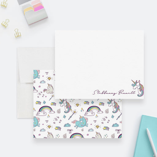 Personalized unicorn note card front and back, with a script name and a pattern of colorful unicorns, rainbows, stars and magic wands.