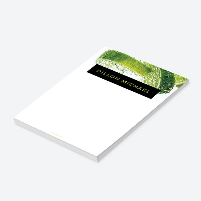 Modern personalized notepad with lime and soda bubbles, featuring a name in green on a black banner. Perfect for professionals or as event gift favors.-side