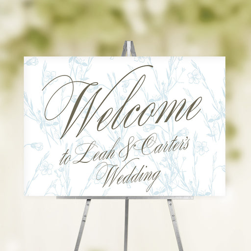 Elegant floral wedding welcome sign featuring calligraphy and a botanical background, personalized with the couple’s names and event details.