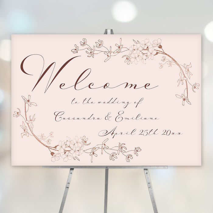 blush pink floral wedding welcome sign with vintage botanical line art and elegant script lettering displayed on an easel