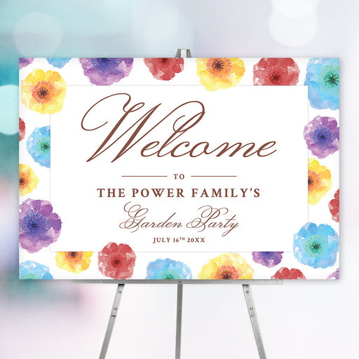 colorful watercolor floral garden party welcome sign with elegant lettering, personalized family text, and easel display