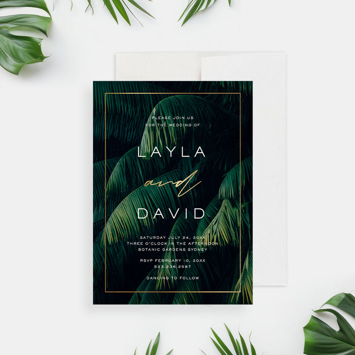 Elegant tropical wedding invitation featuring botanical palm leaves and a gold frame-front
