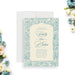Vintage blue floral wedding invitation with botanical border and elegant typography on an ivory background-front