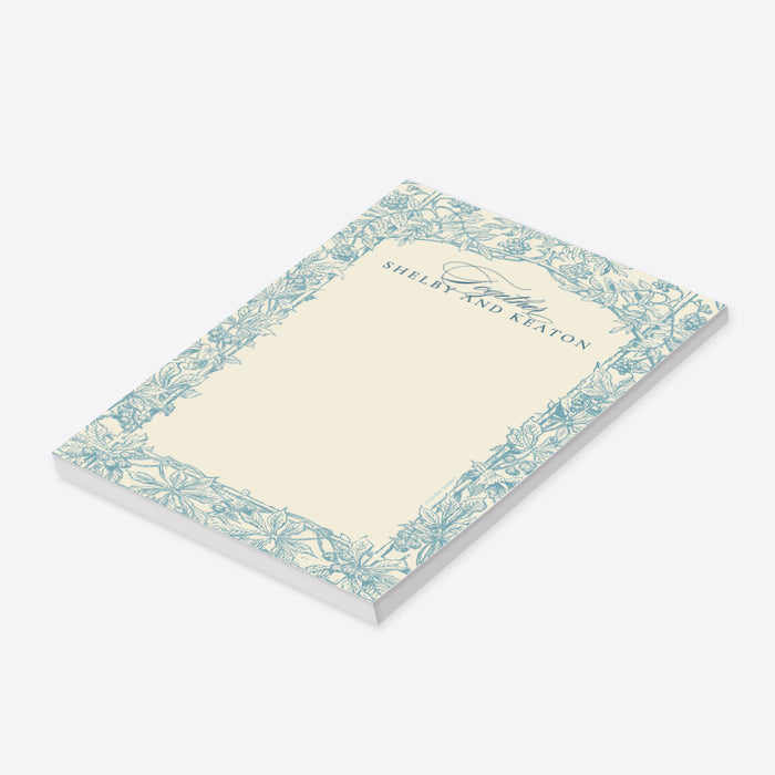 Vintage blue botanical personalized wedding notepad with a floral border and custom names on an ivory background-side