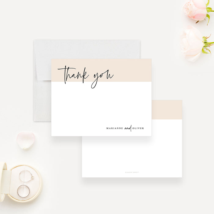 White wedding thank you note card with a beige band, black script lettering and the couple's names below.