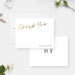 White wedding thank you cards with printed gold script lettering and personalized names on the front and a monogram on the reverse.