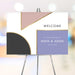 Modern geometric wedding welcome sign with blush, lavender, charcoal color blocks and gold accents
