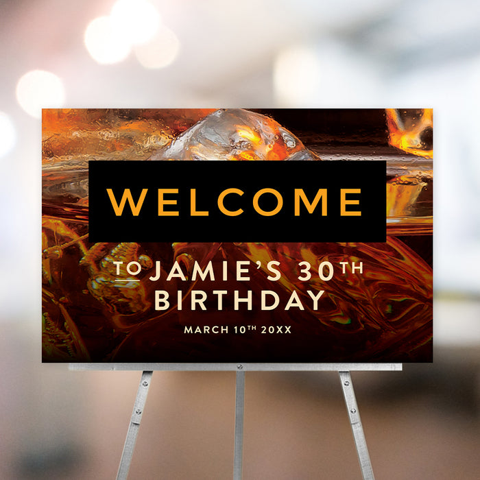 Custom whiskey-themed birthday welcome sign with amber ice background, ideal for men’s milestone parties and stylish event entrances.