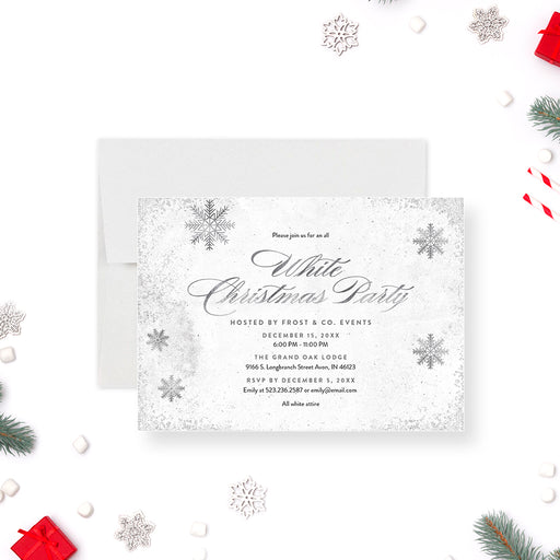 White Christmas party invitation featuring silver snowflakes for elegant holiday events-front