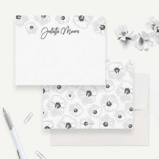 Personalized white floral note card front and back, with dark-centered white flowers, a script name and a matching flower pattern.