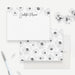 Personalized white floral note card front and back, with dark-centered white flowers, a script name and a matching flower pattern.