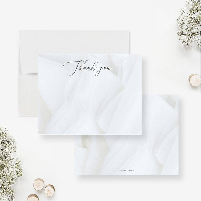 White thank you cards with dark script lettering over a printed folded fabric design on the front and a matching white fabric print reverse.