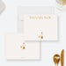 White dinner party thank you note card with gold-colored lettering and a wine bottle and glass illustration.