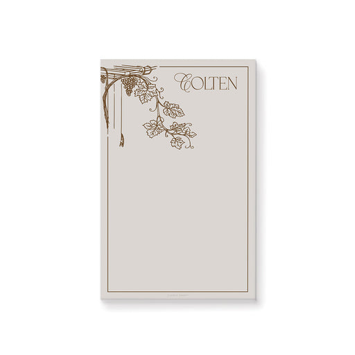 Personalized vineyard notepad featuring a grapevine design, an elegant favor for a 50th birthday celebration.