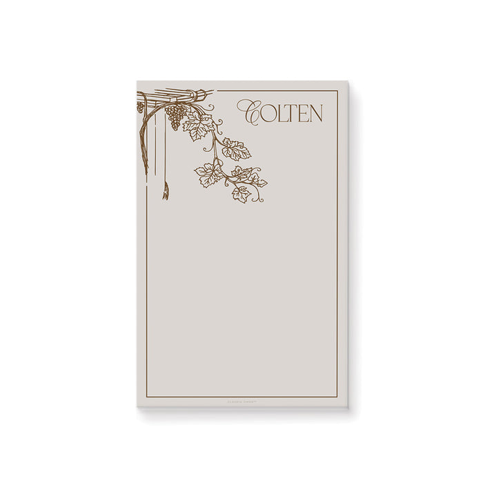 Personalized vineyard notepad featuring a grapevine design, an elegant favor for a 50th birthday celebration.