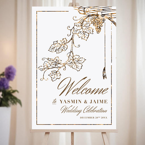 Elegant vineyard wedding welcome sign with grapevine artwork for a rustic winery celebration.