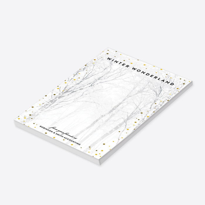 Custom winter wonderland notepad with snow-covered forest design, personalized stationery gift with company name, seasonal party favor, or holiday desk accessory.-side