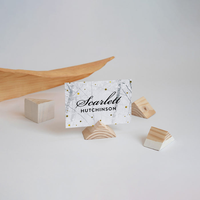 Place card with a winter design and wooden holder on a light background