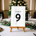 Table number on a stand with a Christmas tree in the background