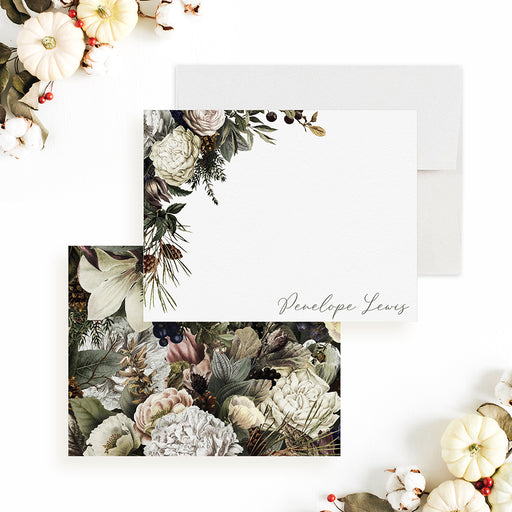 Personalized winter floral note card front and back, with cream flowers, muted pink blooms, greenery and a script name.