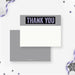 White winter thank you note card with a gray header and pale blue lettering, beside a gray snow-patterned back.