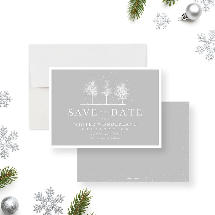 Winter wonderland save the date card featuring snowy trees on a soft gray background with elegant minimalist typography.-front-back