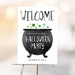 Halloween party welcome sign with a black cauldron and green potion bubbles, a spooky witch-themed party decoration.