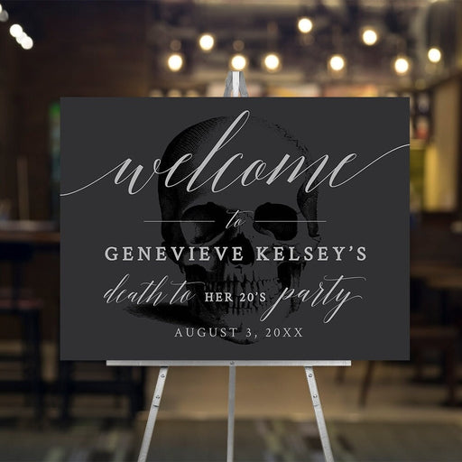Death to Your 20s birthday welcome sign with skull artwork and pale script on charcoal.