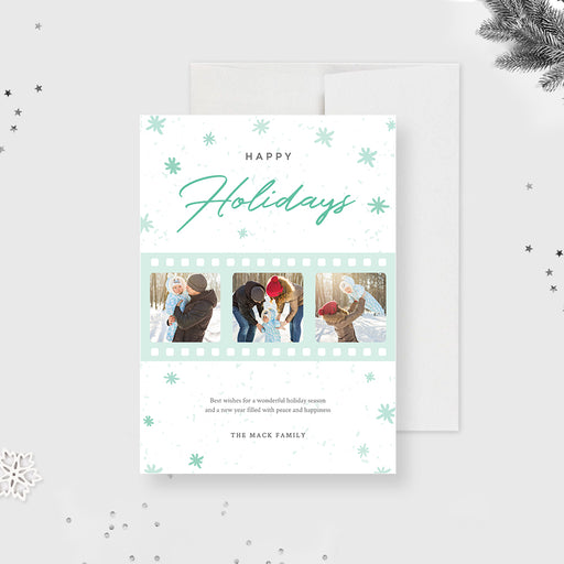 Happy holidays photo card featuring mint green film strip design and family photos