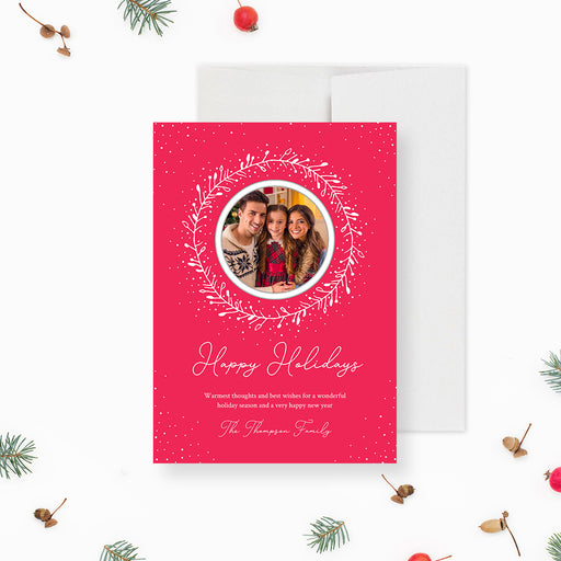 A red and white holiday greeting card with a family photo and the text 'Happy Holidays' on it